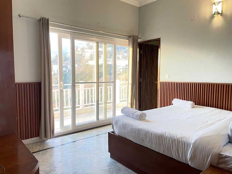 A bedroom facing breathtaking panoramic views of the mountains.