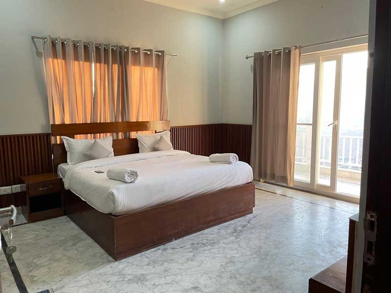 Cozy bedroom facing expansive vistas of the mountains.